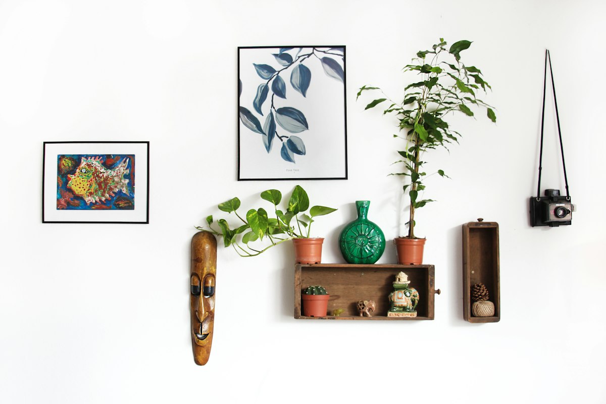 Curated shelf vignette with handcrafted ceramic vessels, art books, and sculptural decor