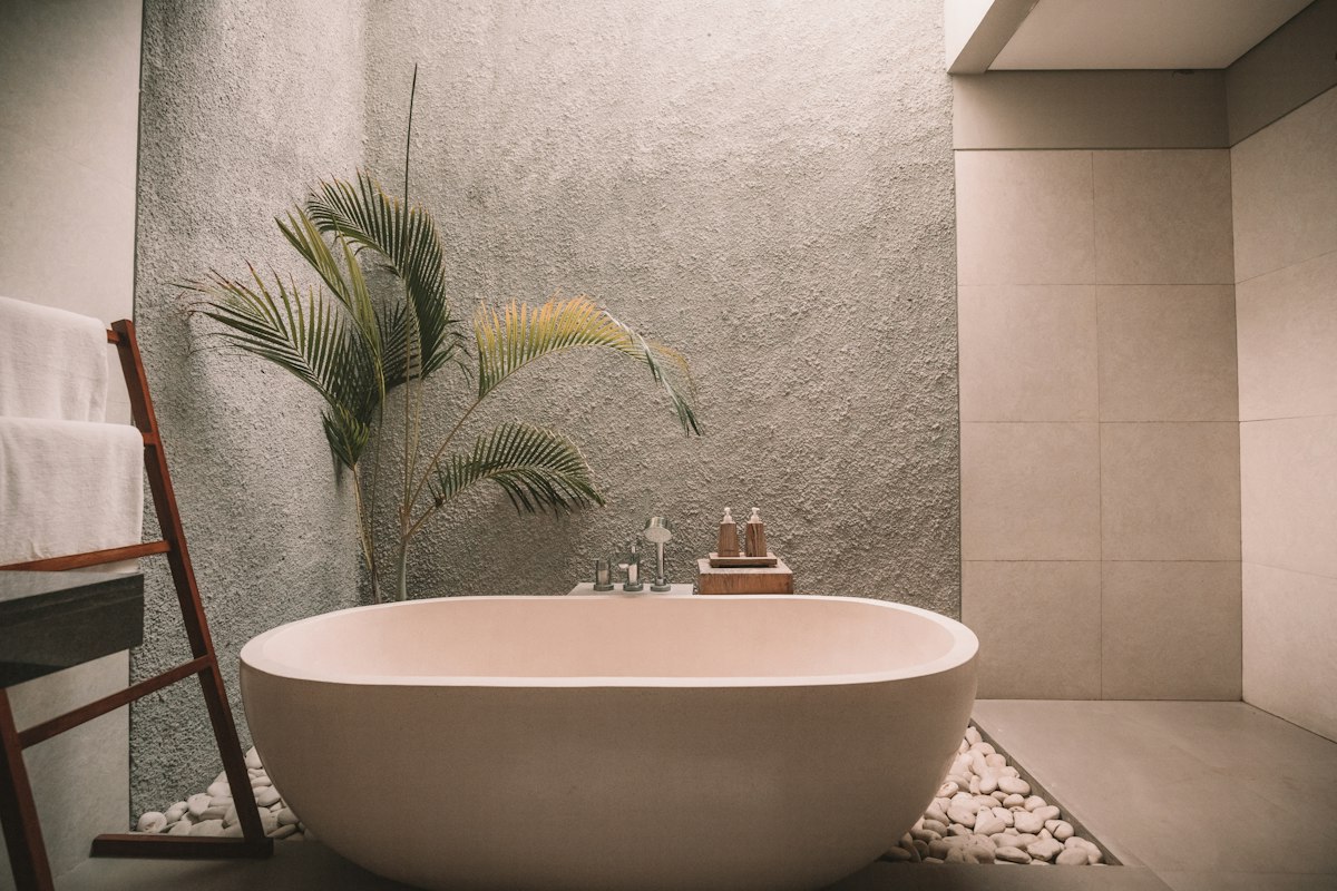 Luxurious spa-like bathroom retreat with freestanding soaking tub and natural stone accents