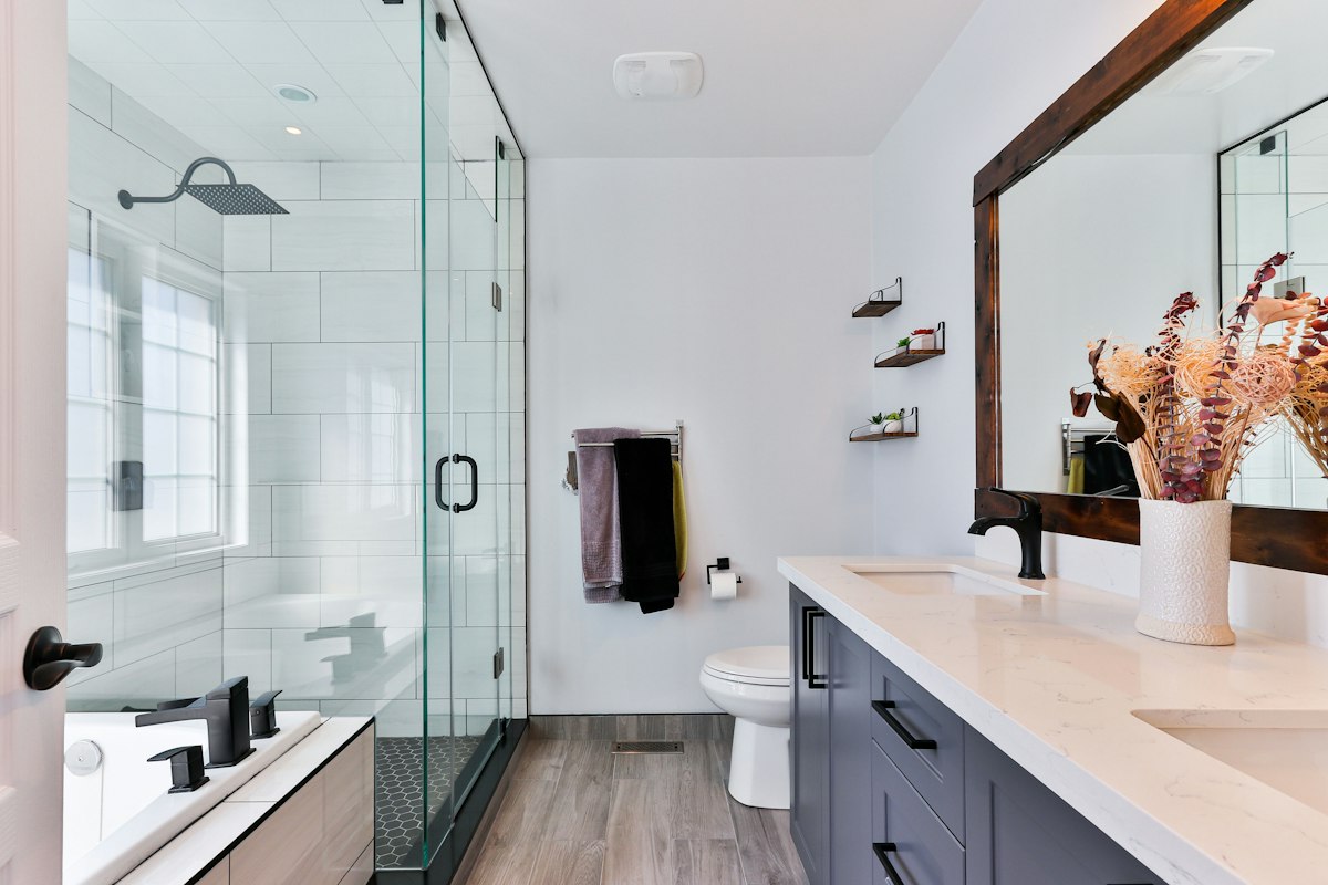 Modern curbless walk-in shower renovation with frameless glass and integrated niche