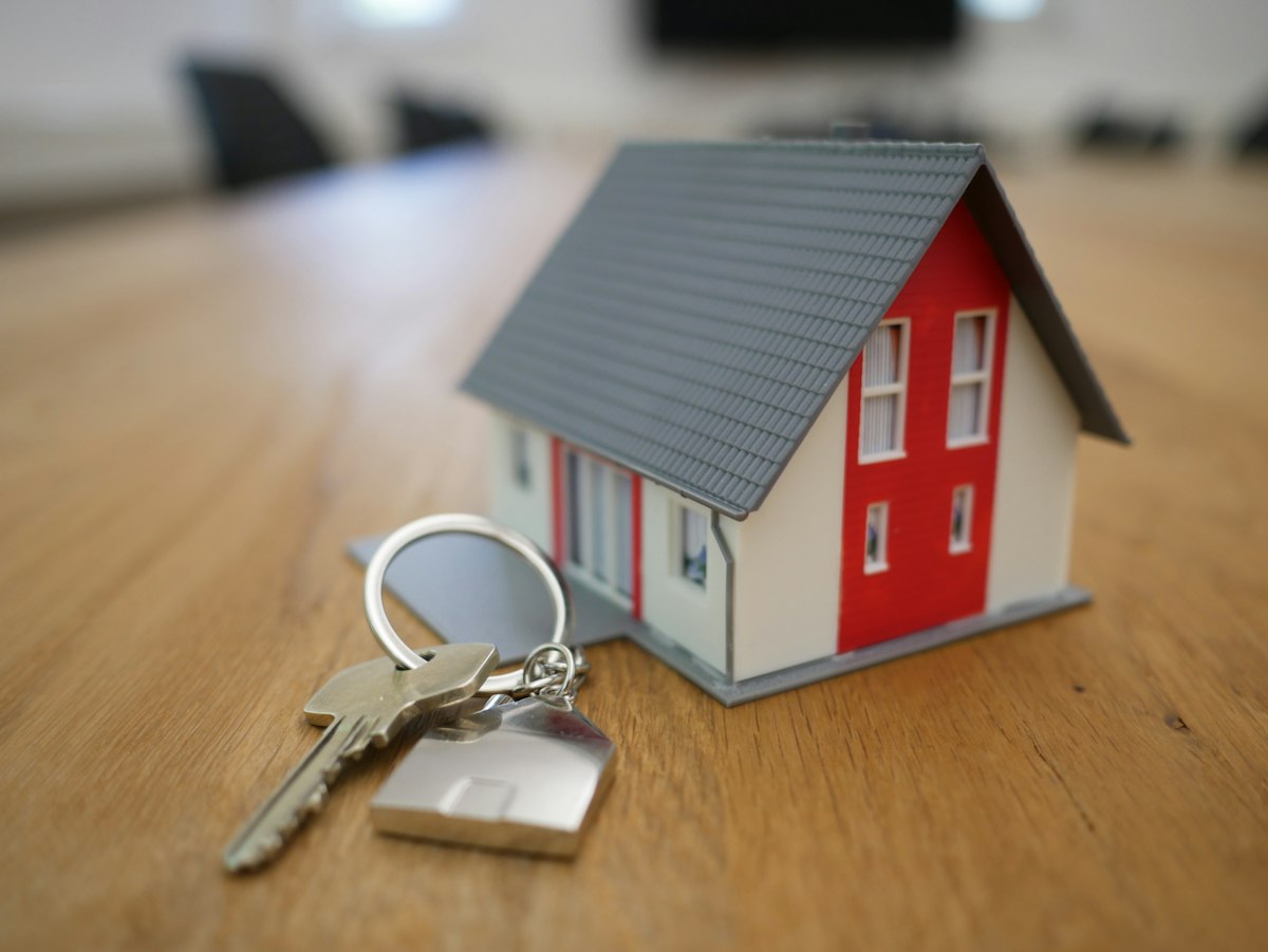 Real estate home purchase contract, set of house keys, and closing escrow documents