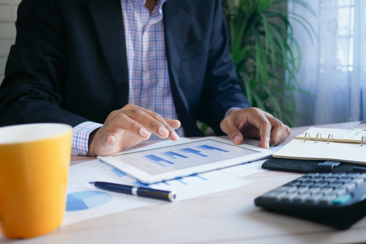 Real estate appraisal valuation forms and comparable market analysis report on clipboard
